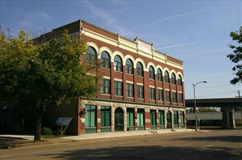 a large brick building on the side of a street