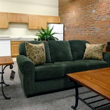 a living room with a green couch and a table