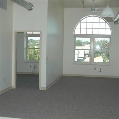 an empty living room with a large window