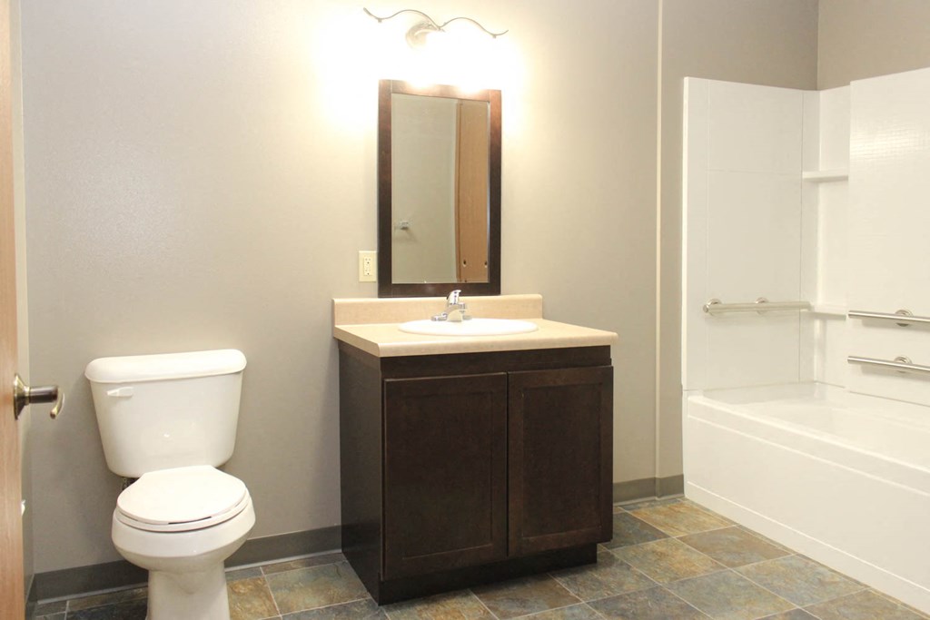 a bathroom with a toilet and a sink and a shower