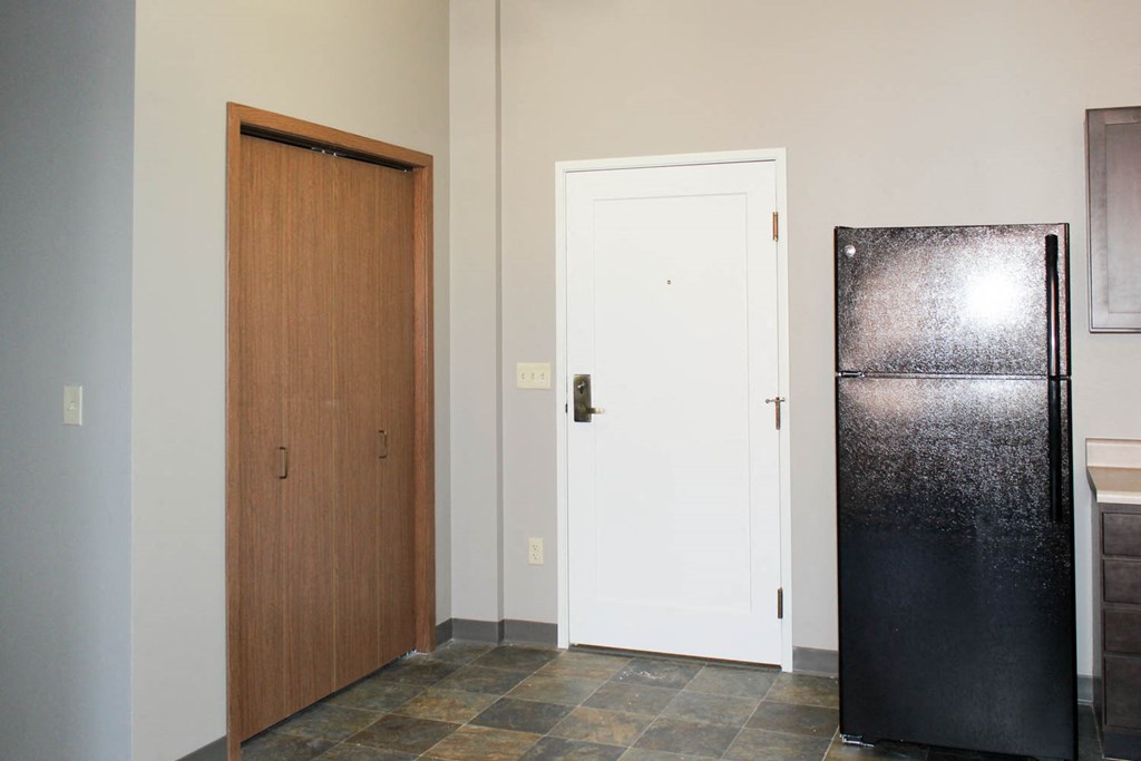 a kitchen with a refrigerator and a door