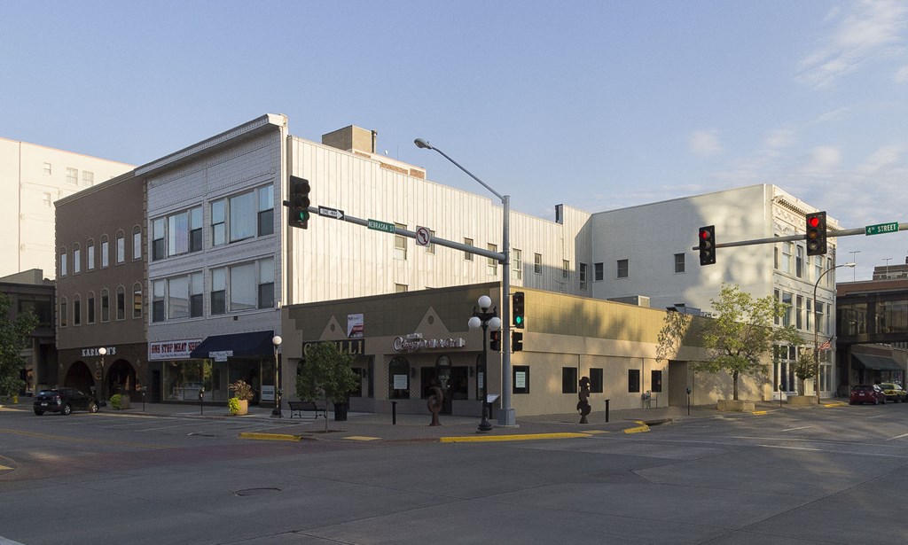 a large building on the corner of a street with a traffic light
