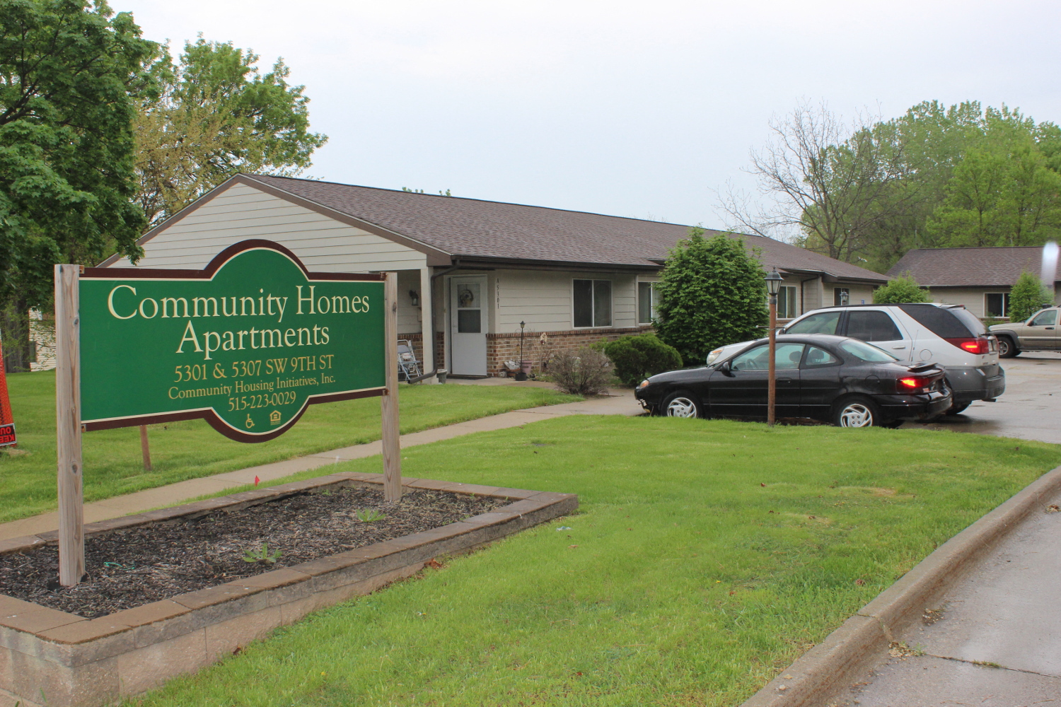 the community homes apartments sign in front of a house
