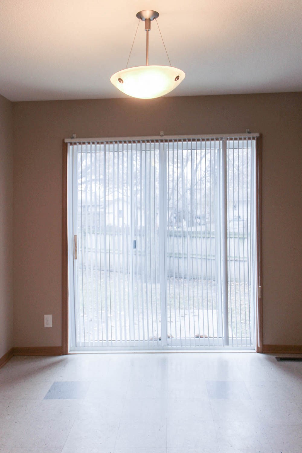 an empty living room with a sliding glass door