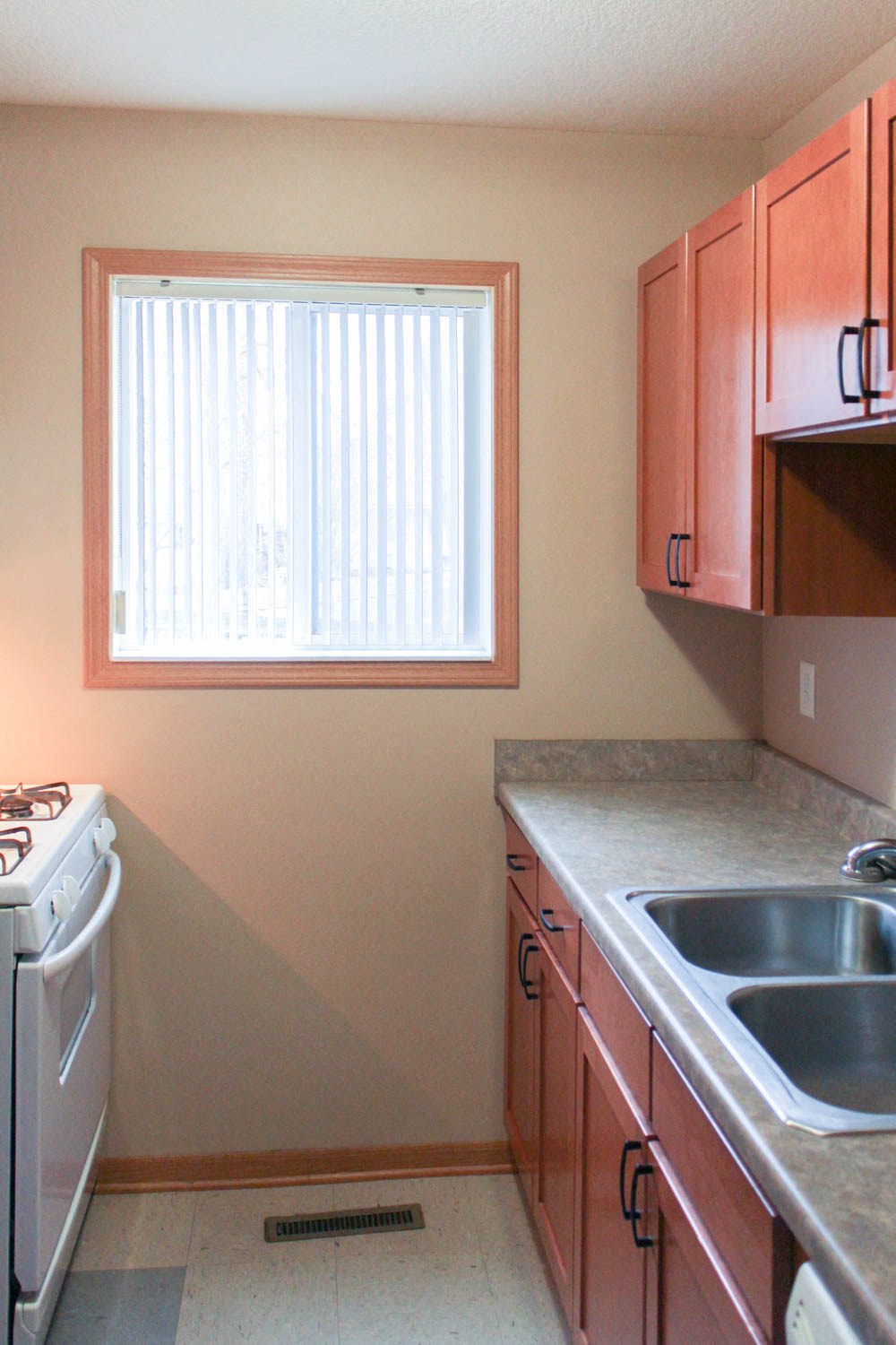 a kitchen with a sink and a stove and a window