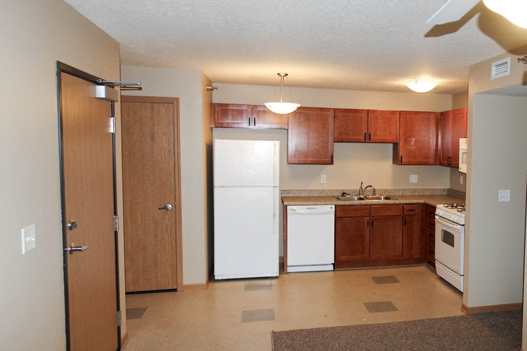 a kitchen with a white refrigerator and a sink