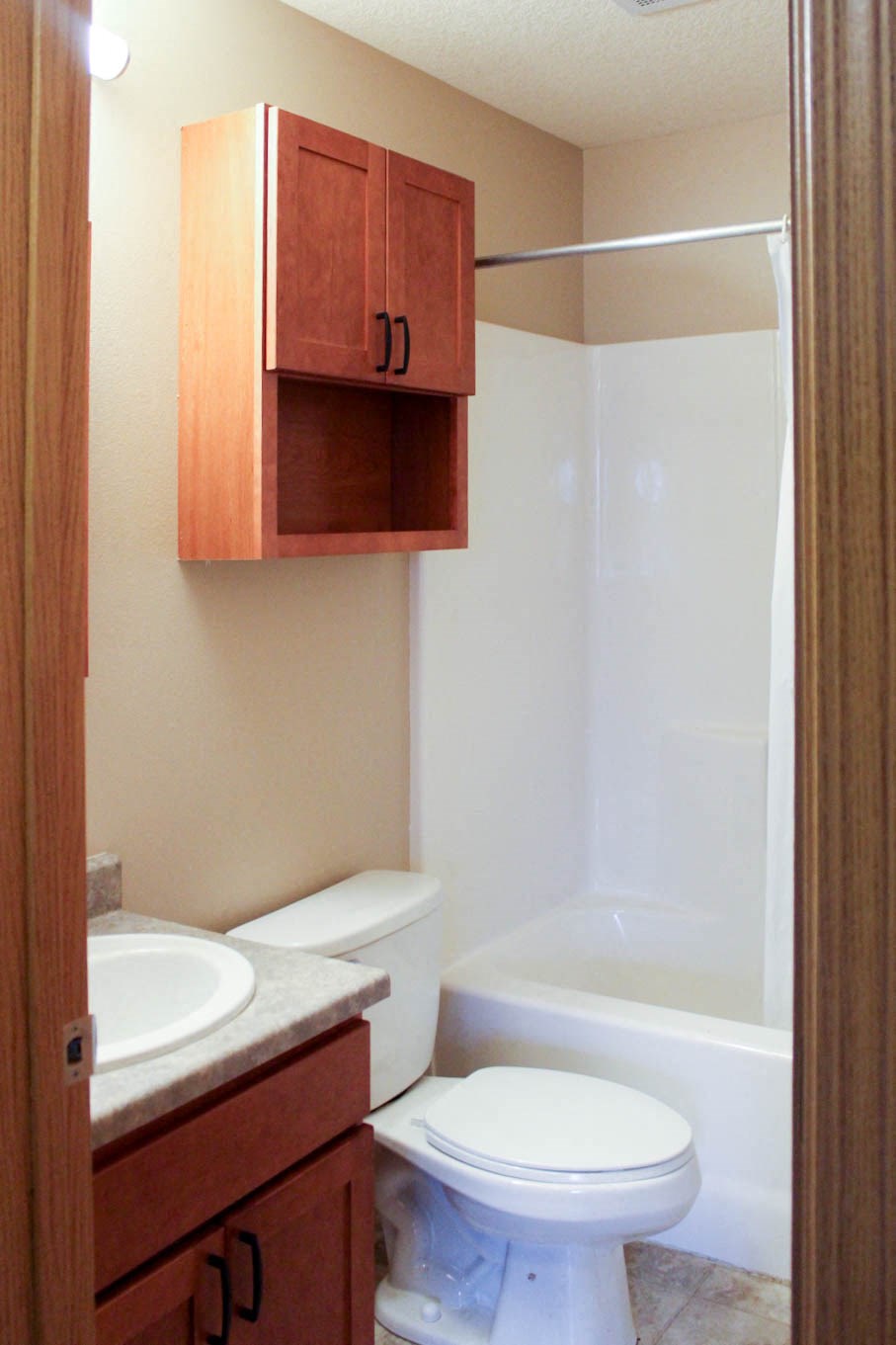 a bathroom with a toilet and a sink and a bath tub