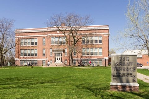 a large brick building with a sign in front of it