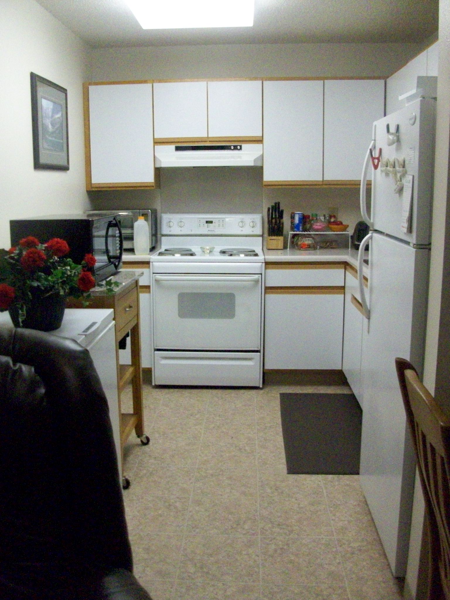 a kitchen with white appliances and white cabinets