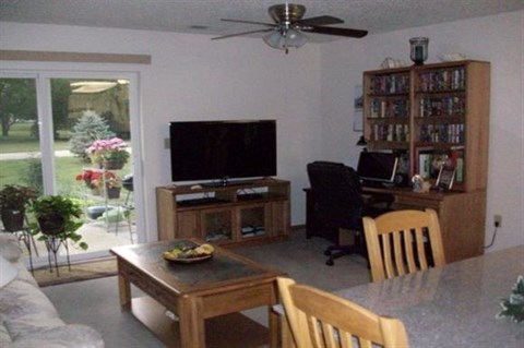 a living room with a television and a table and chairs