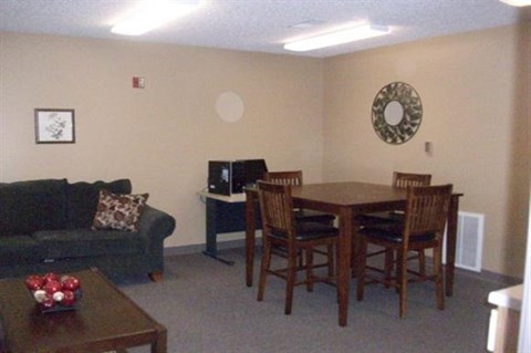 a living room with a table and chairs and a couch