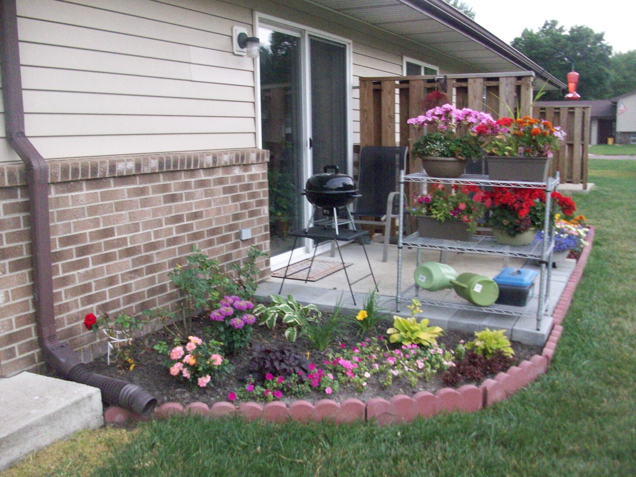 a flower garden in front of a house
