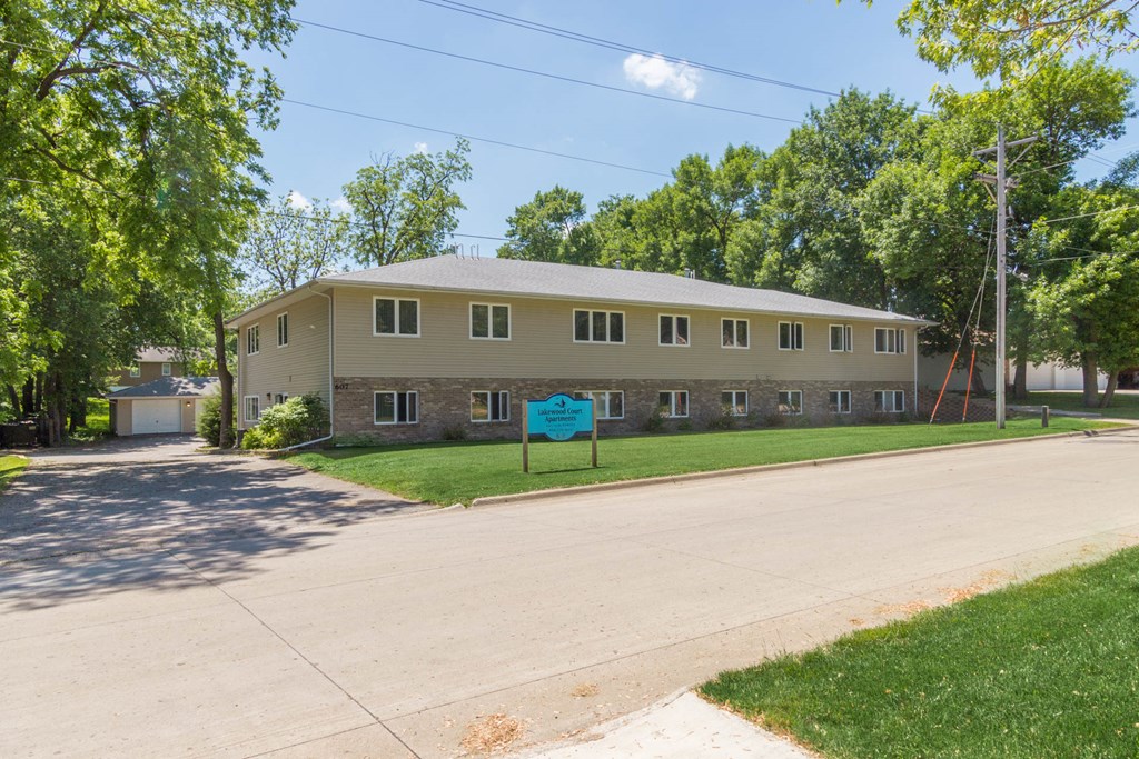 a large building with a blue sign in front of it