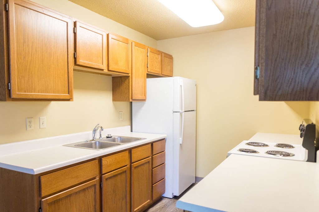 a kitchen with a sink and a refrigerator