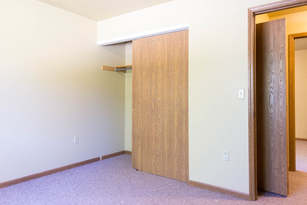 a bedroom with a closet and an open door