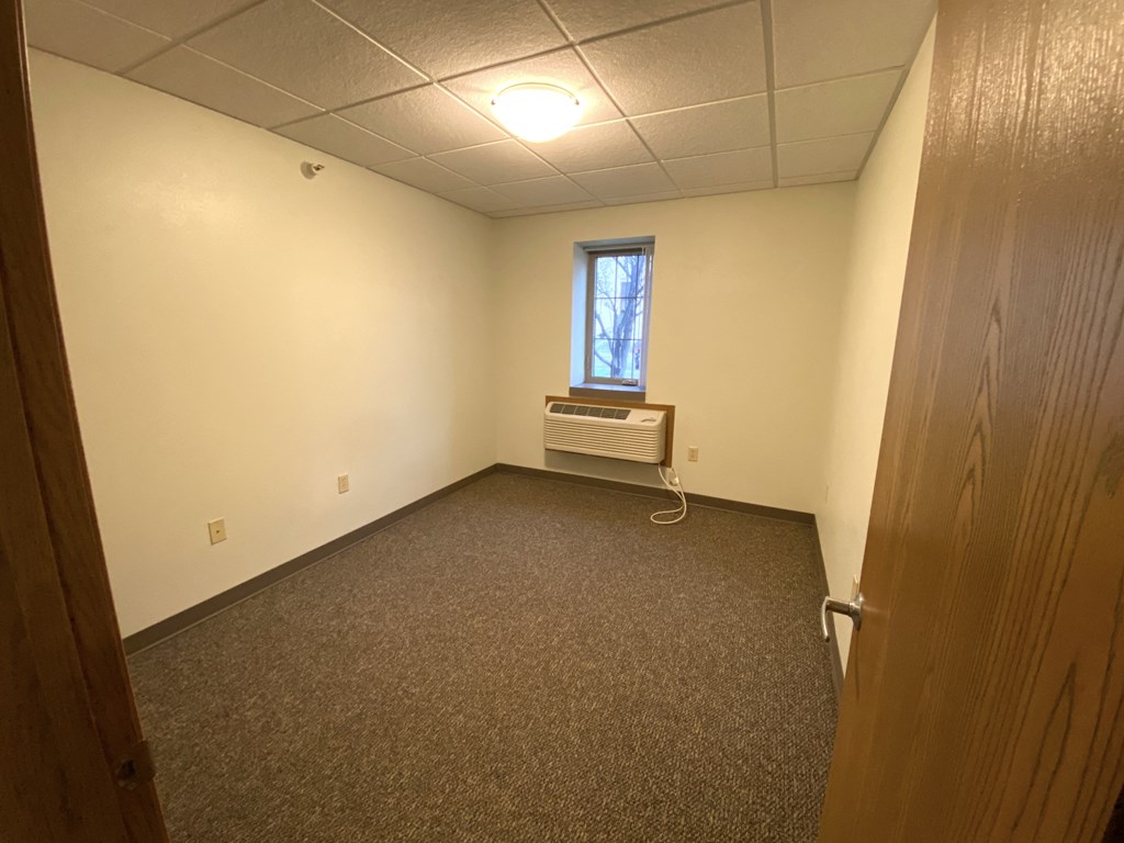 an empty room with a window and a door