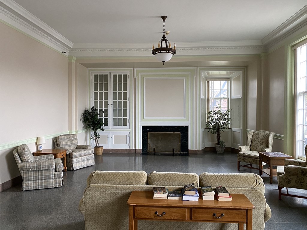 a living room with couches and chairs and a fireplace