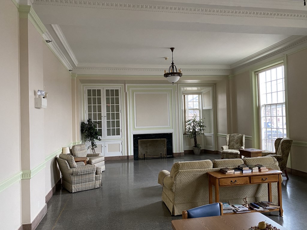 a living room with couches and chairs and a fireplace