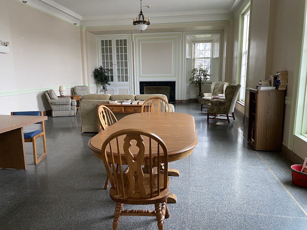 a dining room and living room with a table and chairs