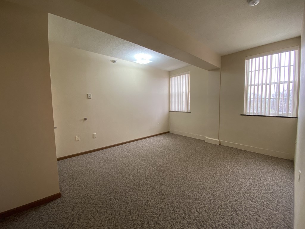 a living room with carpet and a window