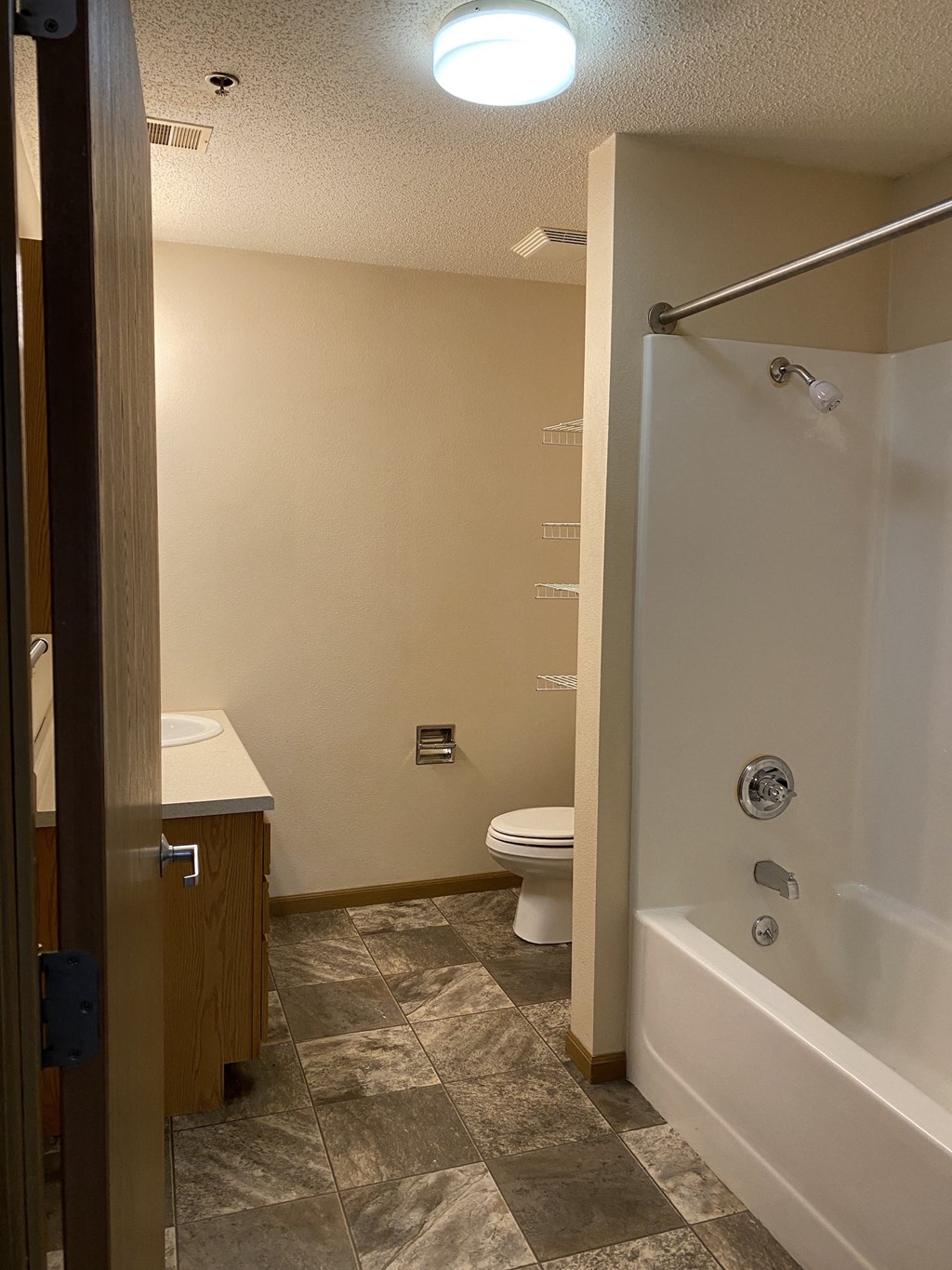 a bathroom with a shower and a toilet and a sink