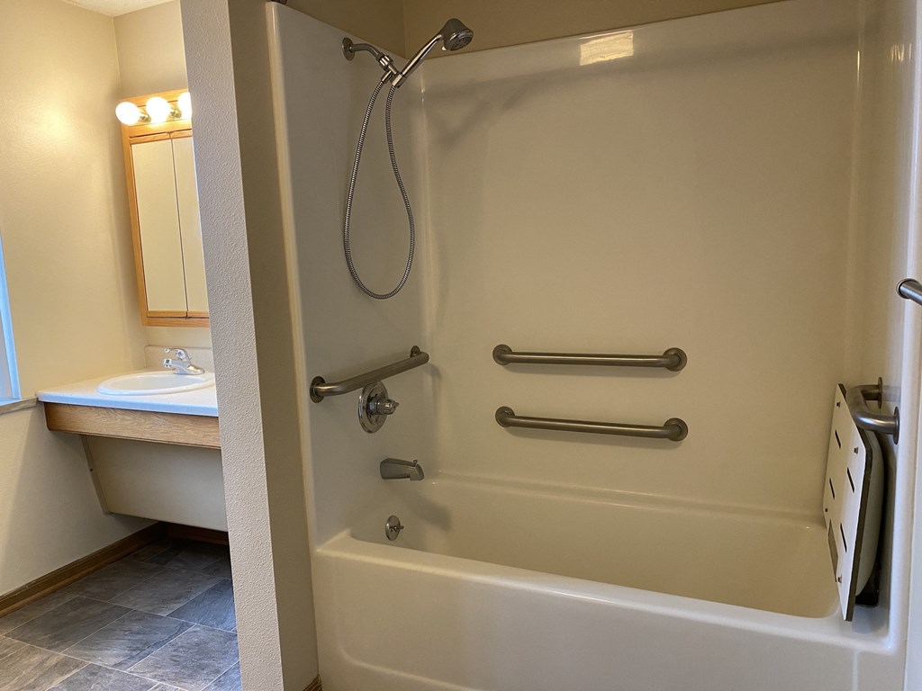 a bathroom with a shower and a sink and a bath tub