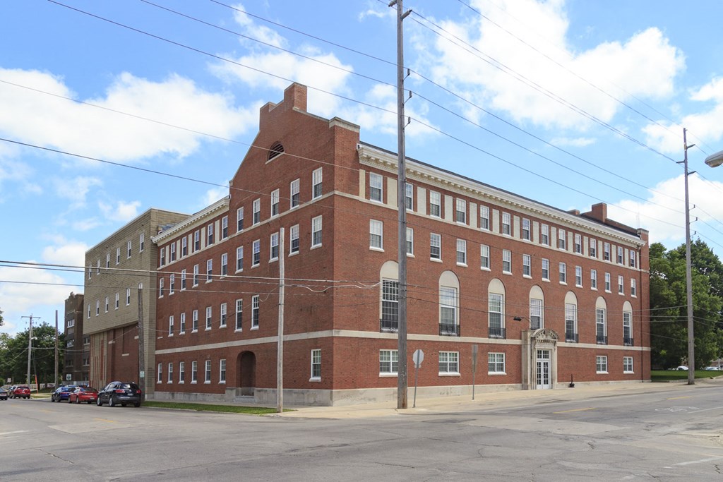a large brick building on the corner of a street
