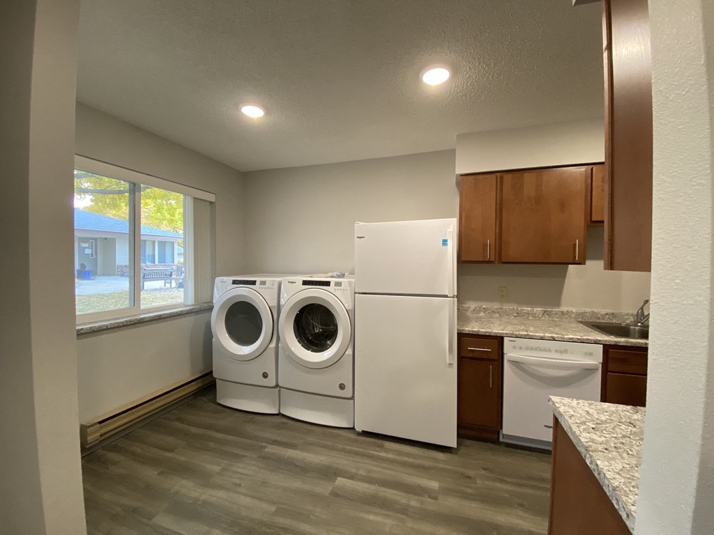 an empty laundry room with a washer and dryer in it