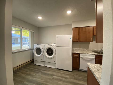 an empty laundry room with a washer and dryer in it