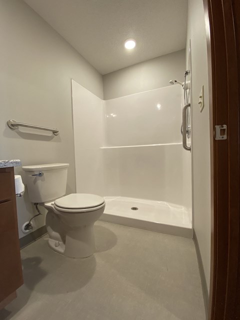 a small bathroom with a toilet and a shower