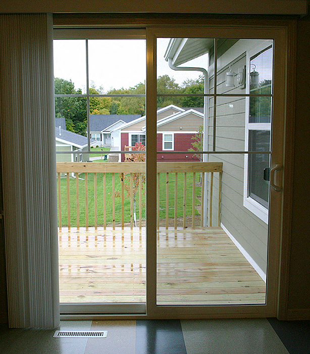 a sliding glass door with a view of a deck