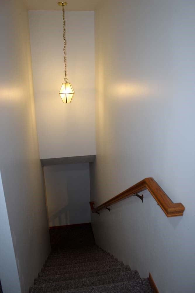 a stairway with a light hanging from the ceiling