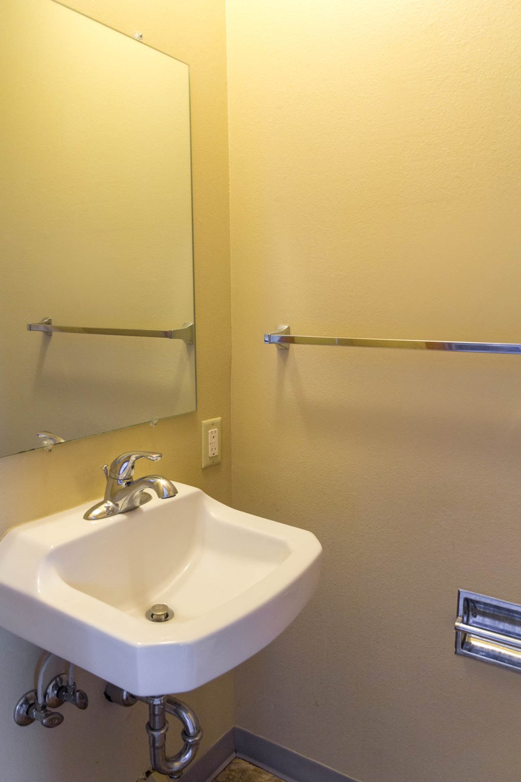 a bathroom with a white sink and a mirror