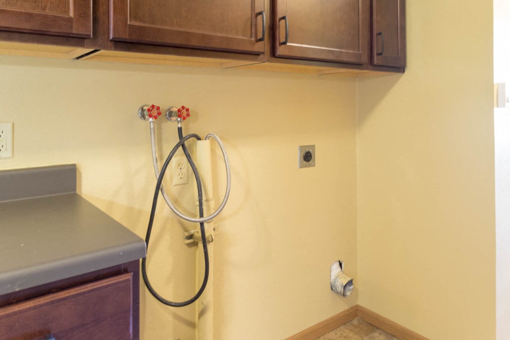 a kitchen with a hose on the wall