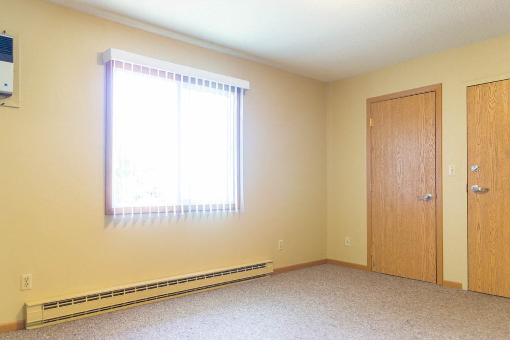 a empty room with a window and a door