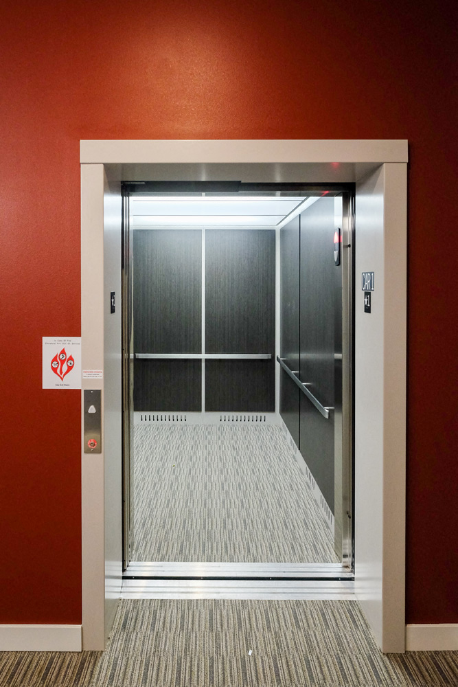 an open elevator in a building with a carpeted floor