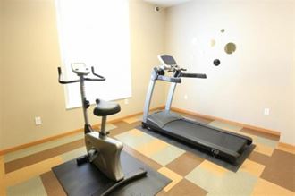 a workout room with two exercise machines in it