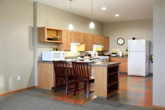 a kitchen with a table and a refrigerator