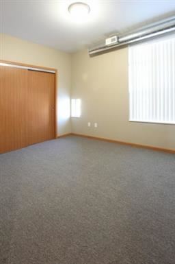 an empty room with a door and a window