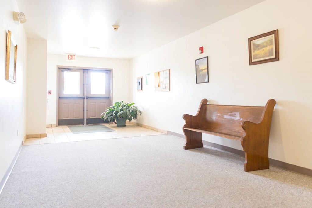 a living room with a bench and a door