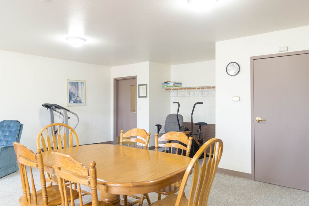 a dining room with a table and chairs