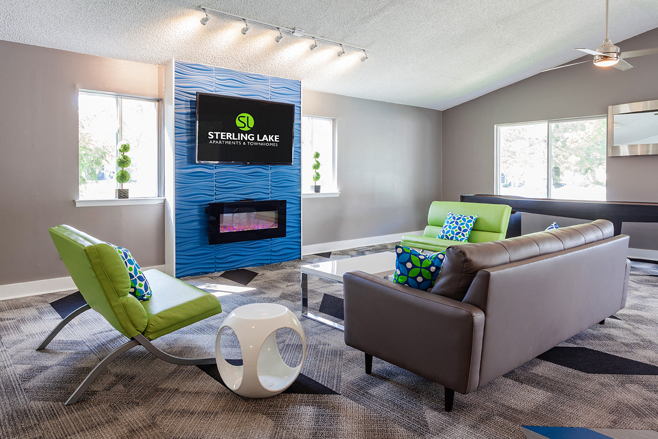 a living room with couches and chairs and a fireplace