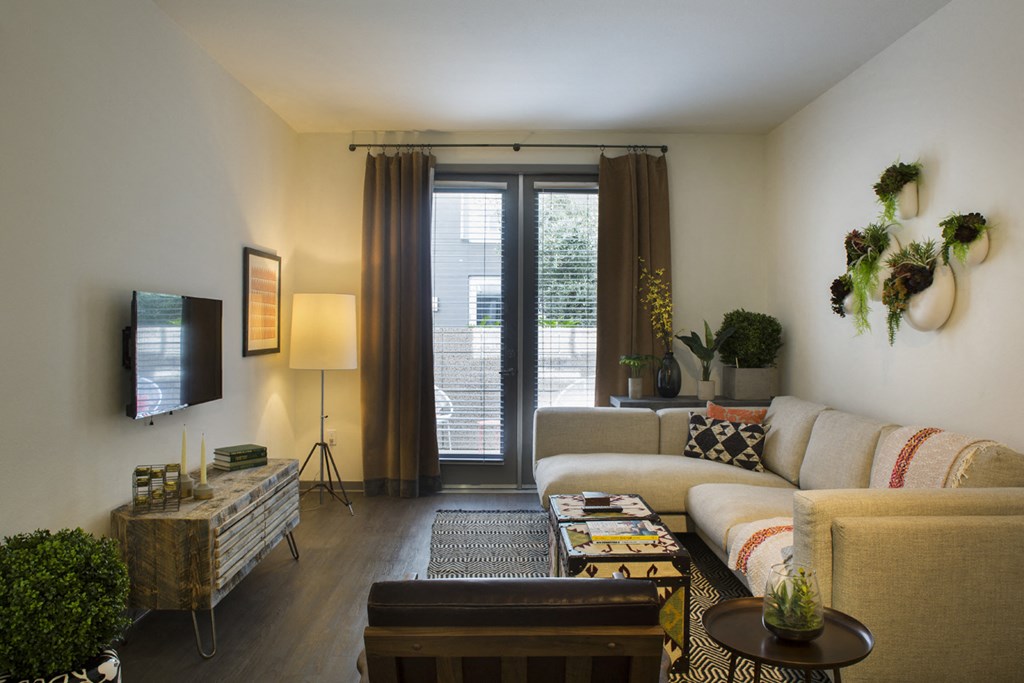 a living room with a couch and a door to a patio
