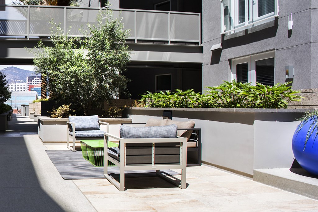 a seating area with chairs and a table on a patio