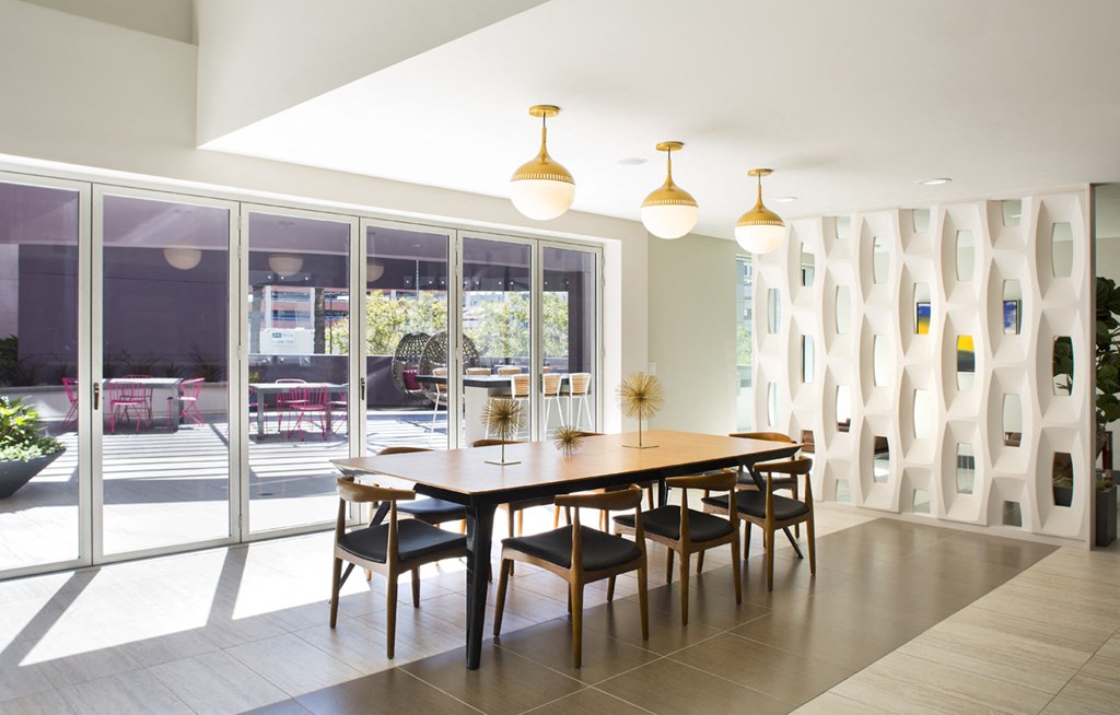 a dining room with a wooden table and chairs
