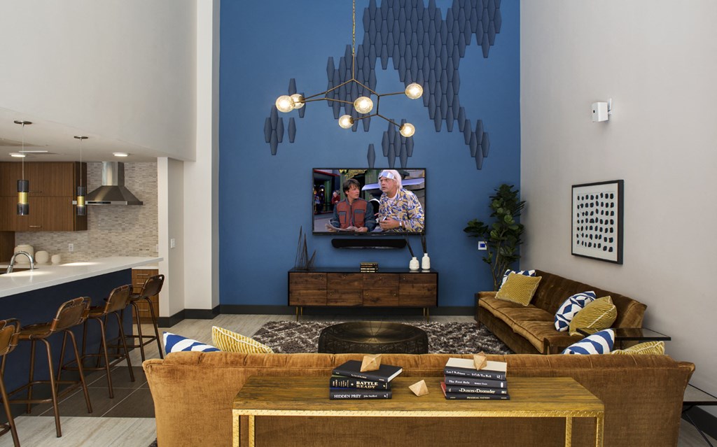 a living room with a blue wall and a couch and a tv
