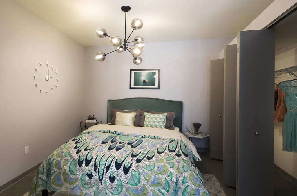 a bedroom with a bed and a chandelier