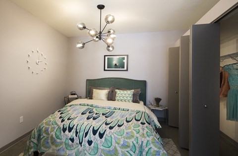 a bedroom with a bed and a chandelier