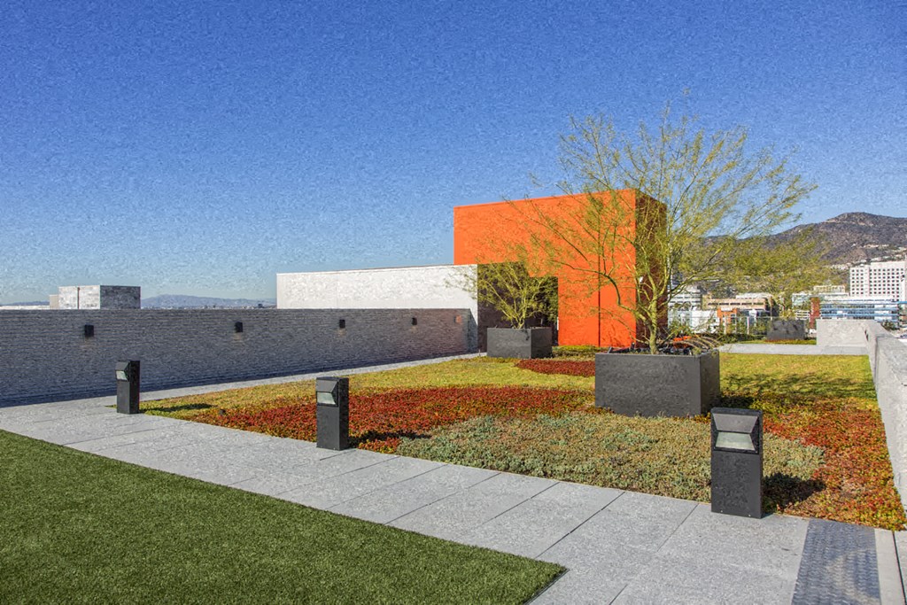 a rendering of a house with a garden and a city in the background