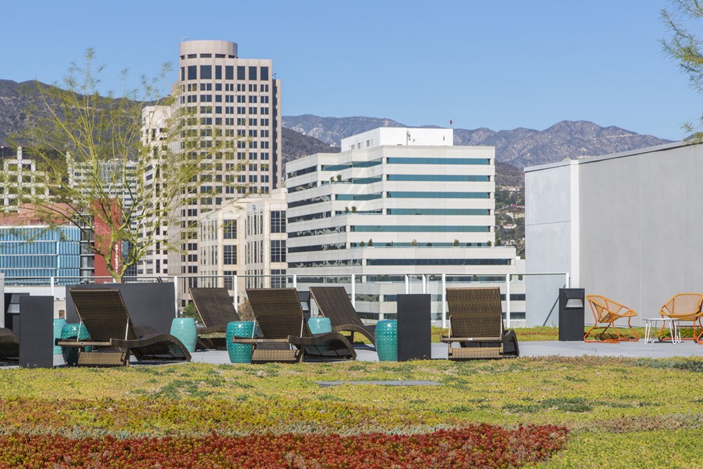 a group of lounge chairs in front of a building in the city